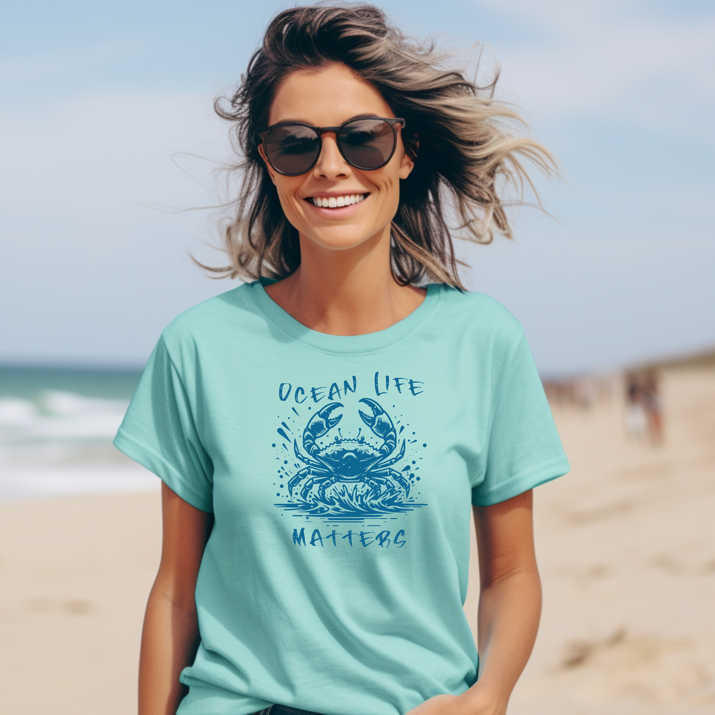 Comfort Colors 1717 "Ocean Life Matters" t shirt with a crab splashing in water in a one color graphic. Picture of a girl standing on the beach wearing a t shirt.