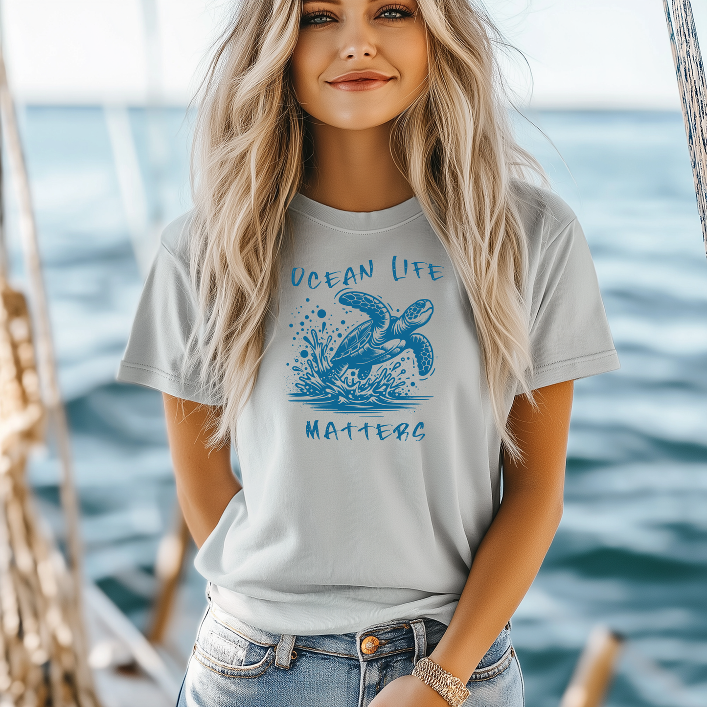 Gildan 5000 "Save The Ocean and The Sea Life In It" t shirt with a sea turtle splashing in water in a one color graphic. Picture of a girl standing on a boat wearing a t shirt.