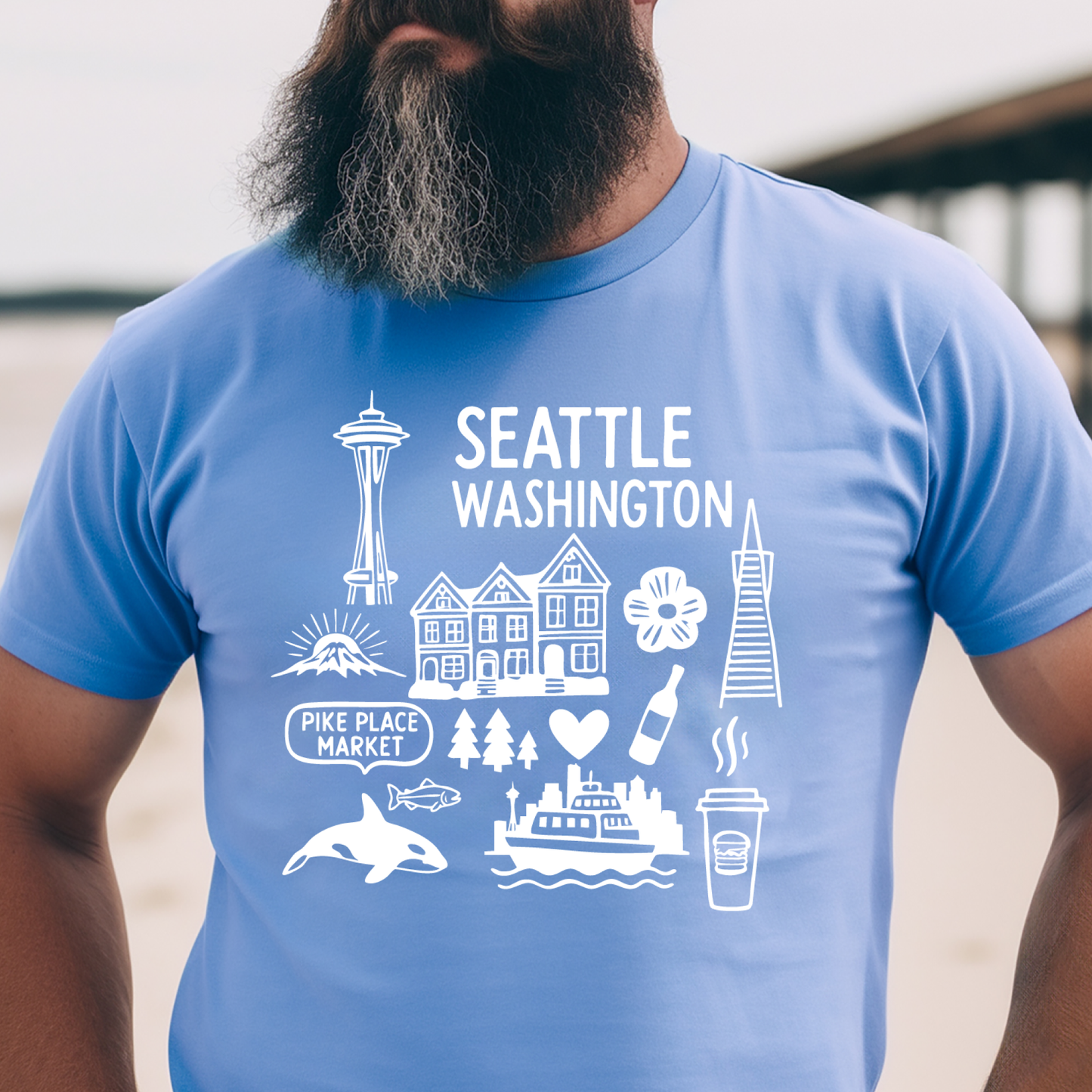 Person wearing a blue t-shirt with white graphics and text about Seattle, Washington.