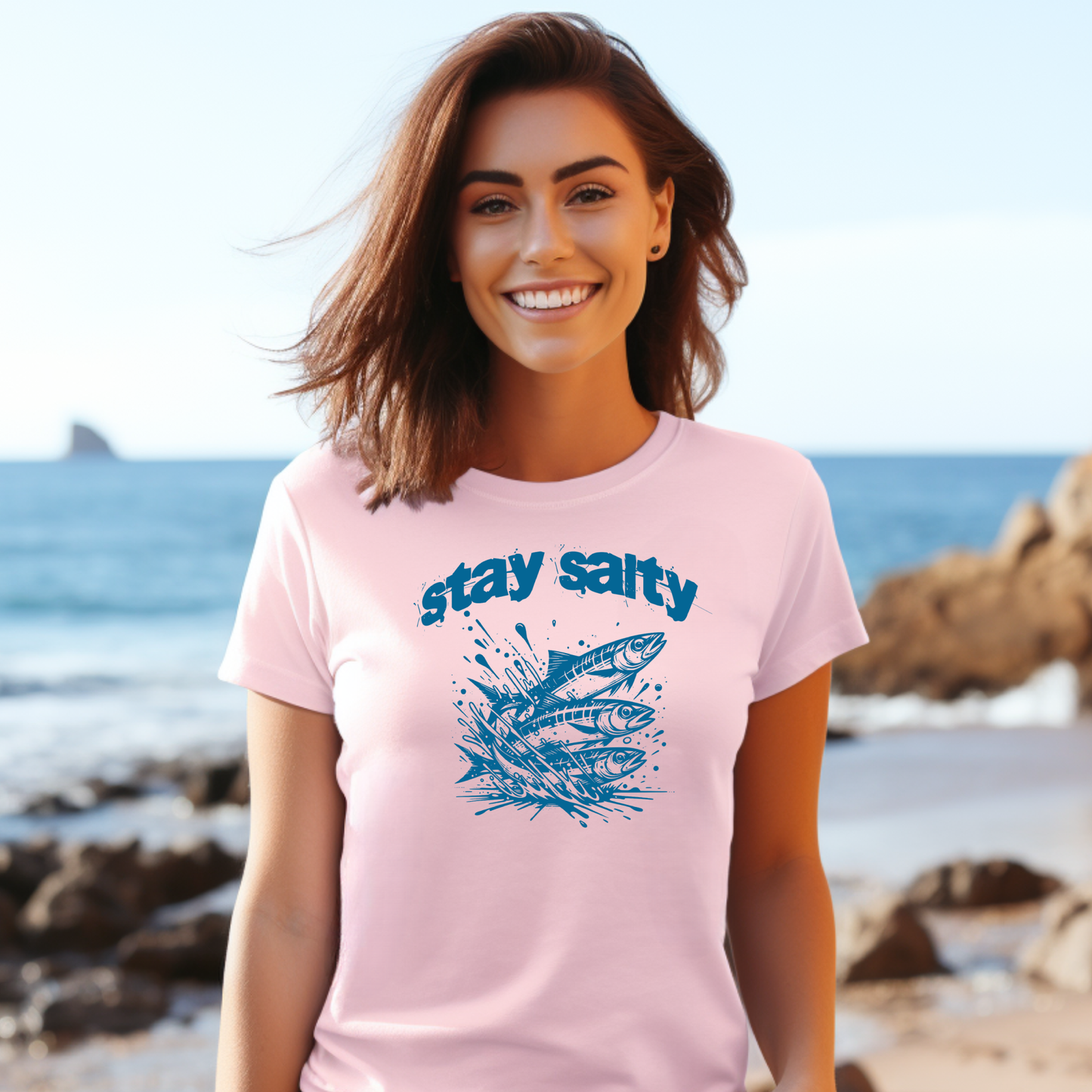 Gildan 5000 "Stay Salty" t shirt with Three Sardines jumping out of water in one color graphics. Picture of a girl standing on the beach wearing a t shirt.