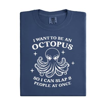 Folded navy blue denim t-shirt with white octopus graphic and text on a white background