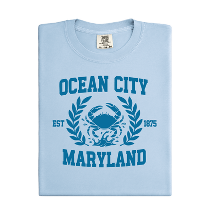 Light blue t-shirt with 'Ocean City, Maryland' design featuring a crab and laurel leaves.