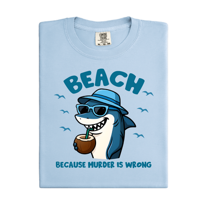 Light blue t-shirt with a cartoon shark design and text on a white background