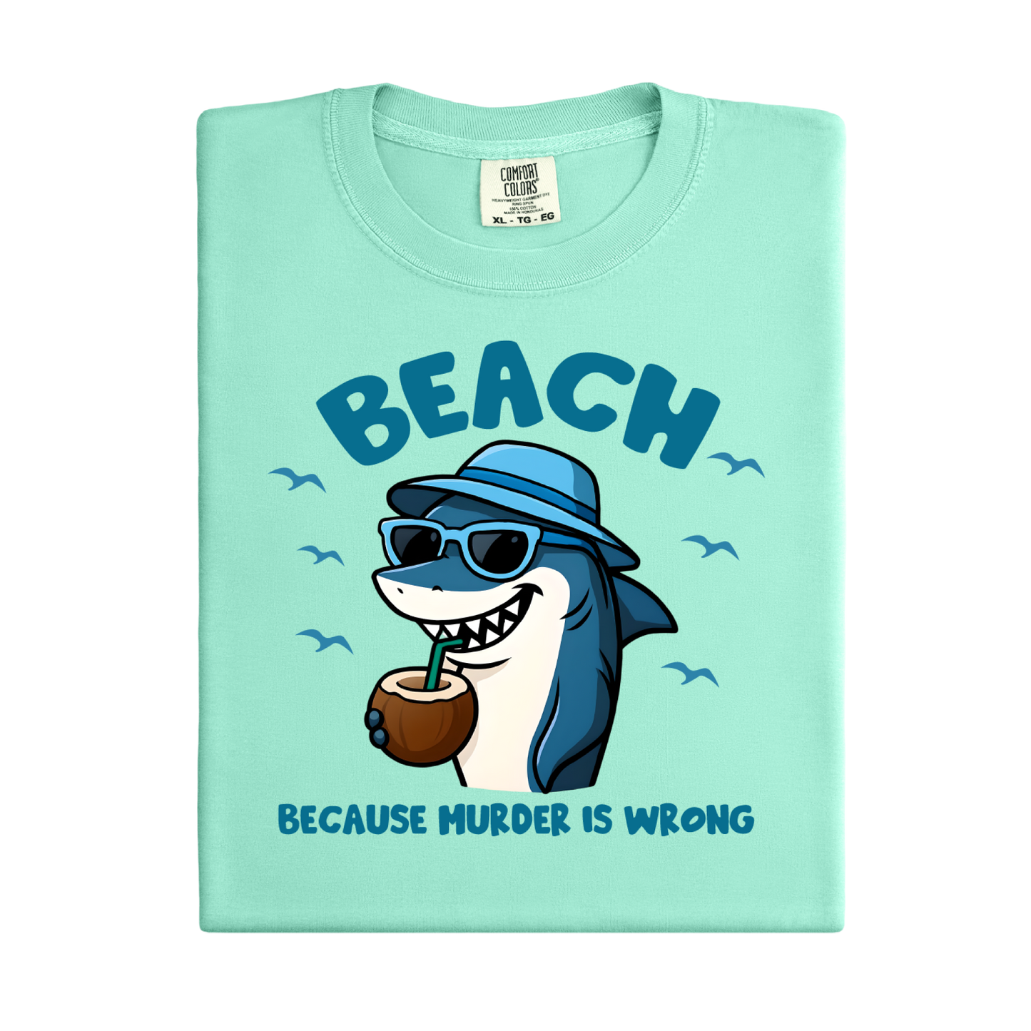 Light green t-shirt with a cartoon shark wearing sunglasses and a hat, holding a coconut, and text 'BEACH BECAUSE MURDER IS WRONG' on a white background.