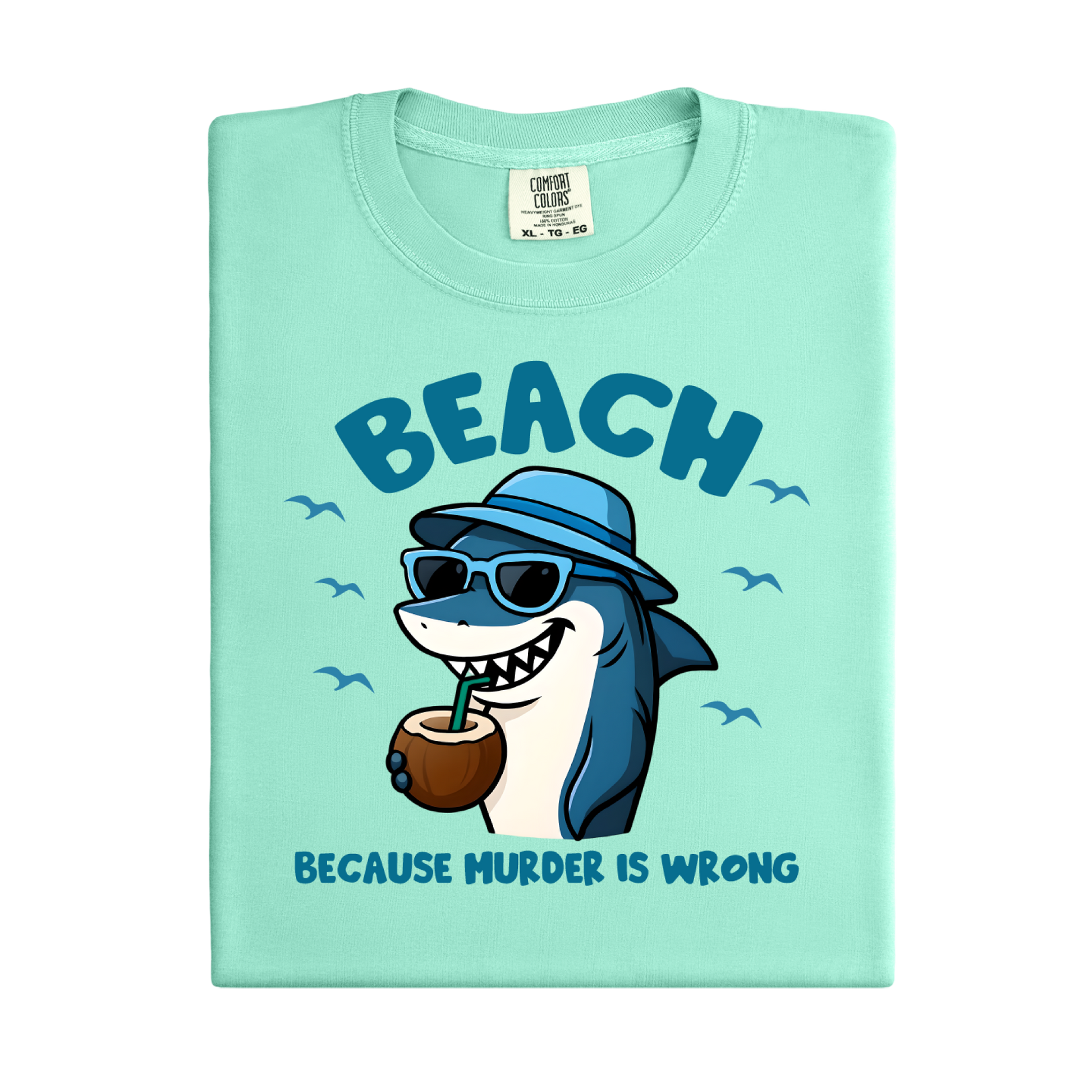 Light green t-shirt with a cartoon shark wearing sunglasses and a hat, holding a coconut, and text 'BEACH BECAUSE MURDER IS WRONG' on a white background.