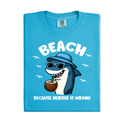 Blue t-shirt with a shark graphic and text on a white background