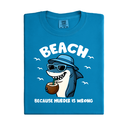 Blue t-shirt with a cartoon shark design and text on a white background