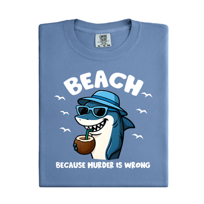 Folded blue t-shirt with a shark graphic and text on a white background