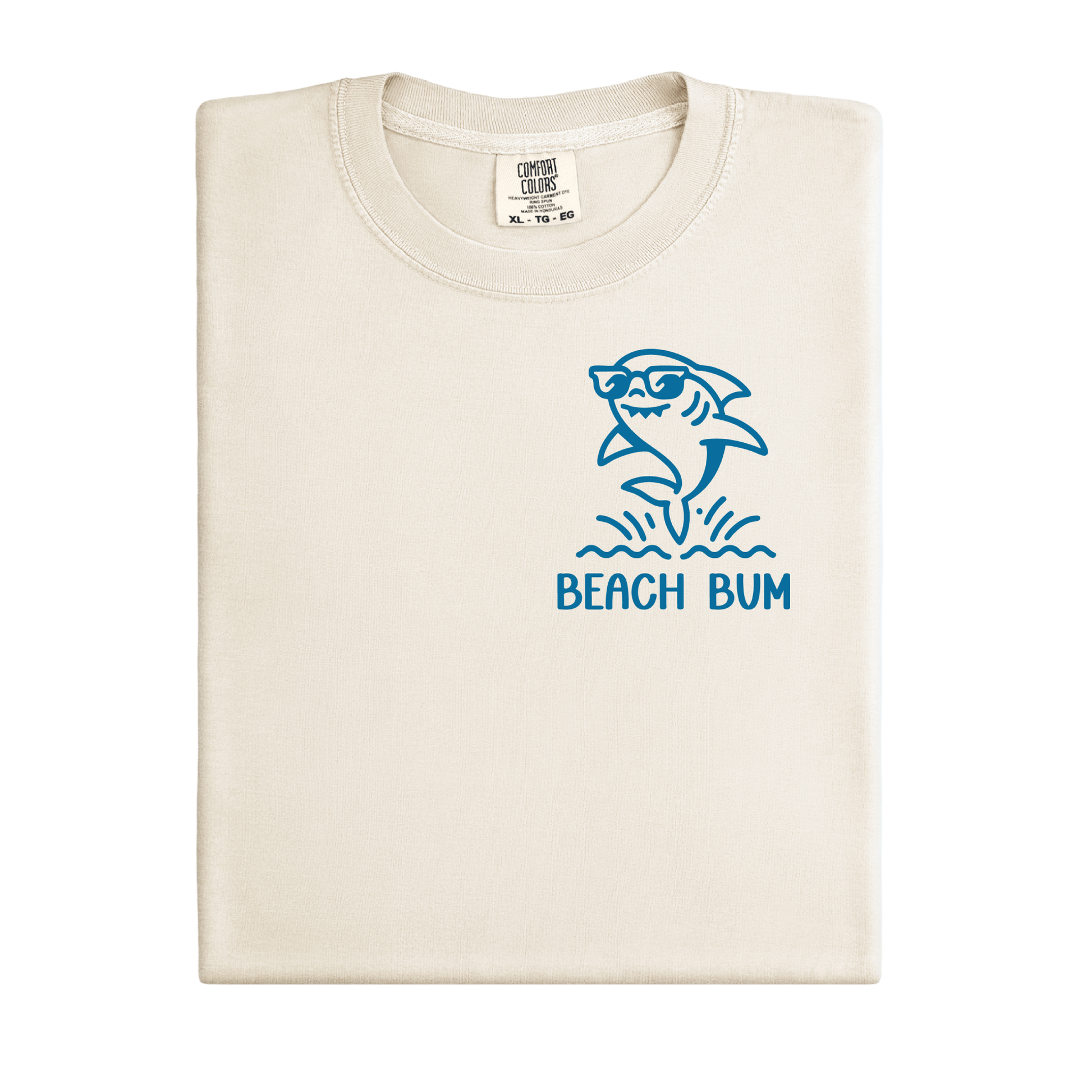 Beige t-shirt with blue shark graphic and 'Beach Bum' text on a white background