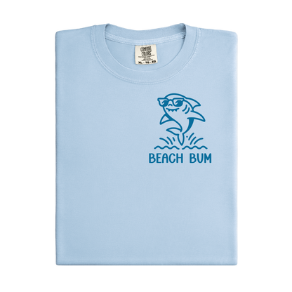 Light blue t-shirt with shark graphic and 'Beach Bum' text on a white background