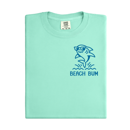 Light green t-shirt with a shark graphic and 'Beach Bum' text on a white background