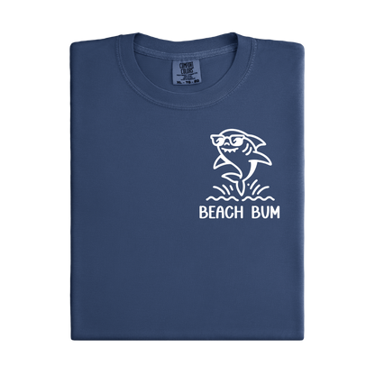 Navy blue t-shirt with a white shark graphic and 'Beach Bum' text on a white background