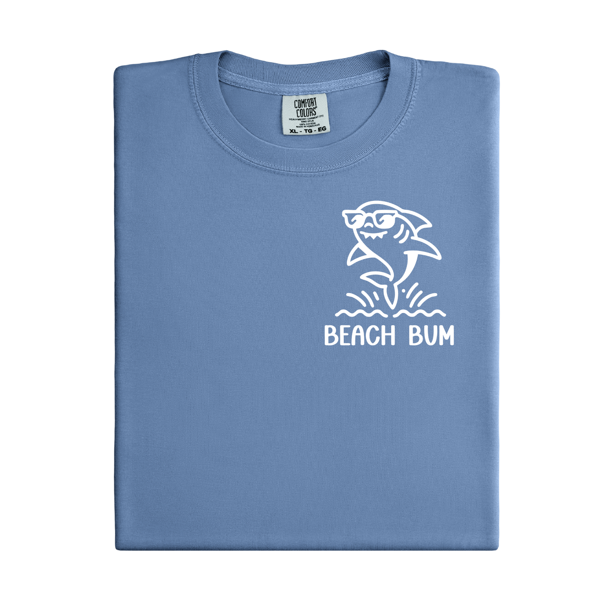 Folded blue t-shirt with a shark graphic and 'Beach Bum' text on a white background