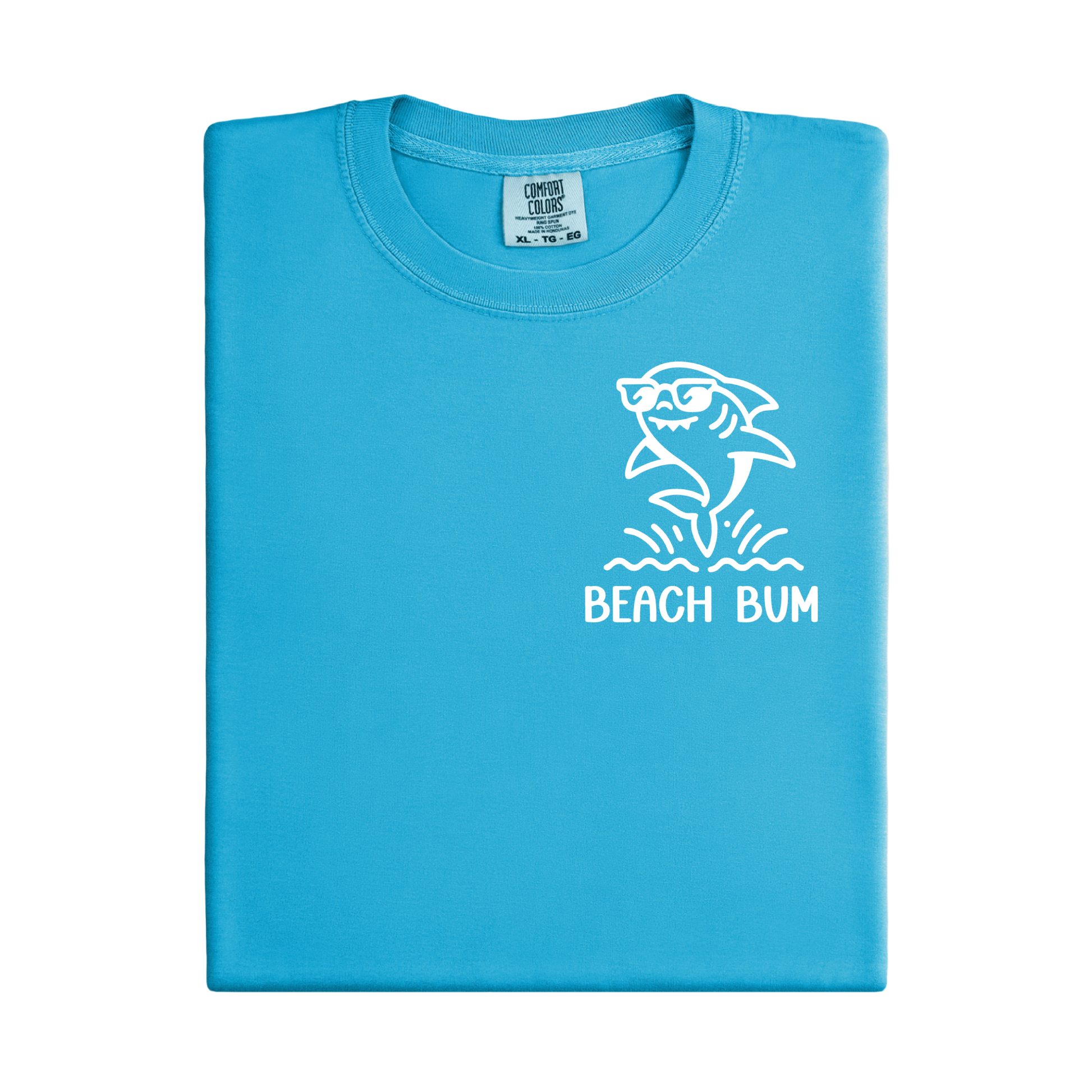 Folded blue t-shirt with a shark graphic and 'Beach Bum' text on a white background