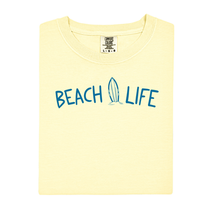 Yellow t-shirt with 'Beach Life' text and surfboard graphic on a white background