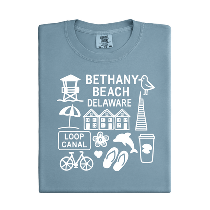 Folded blue t-shirt with white graphics and text about Bethany Beach, Delaware.