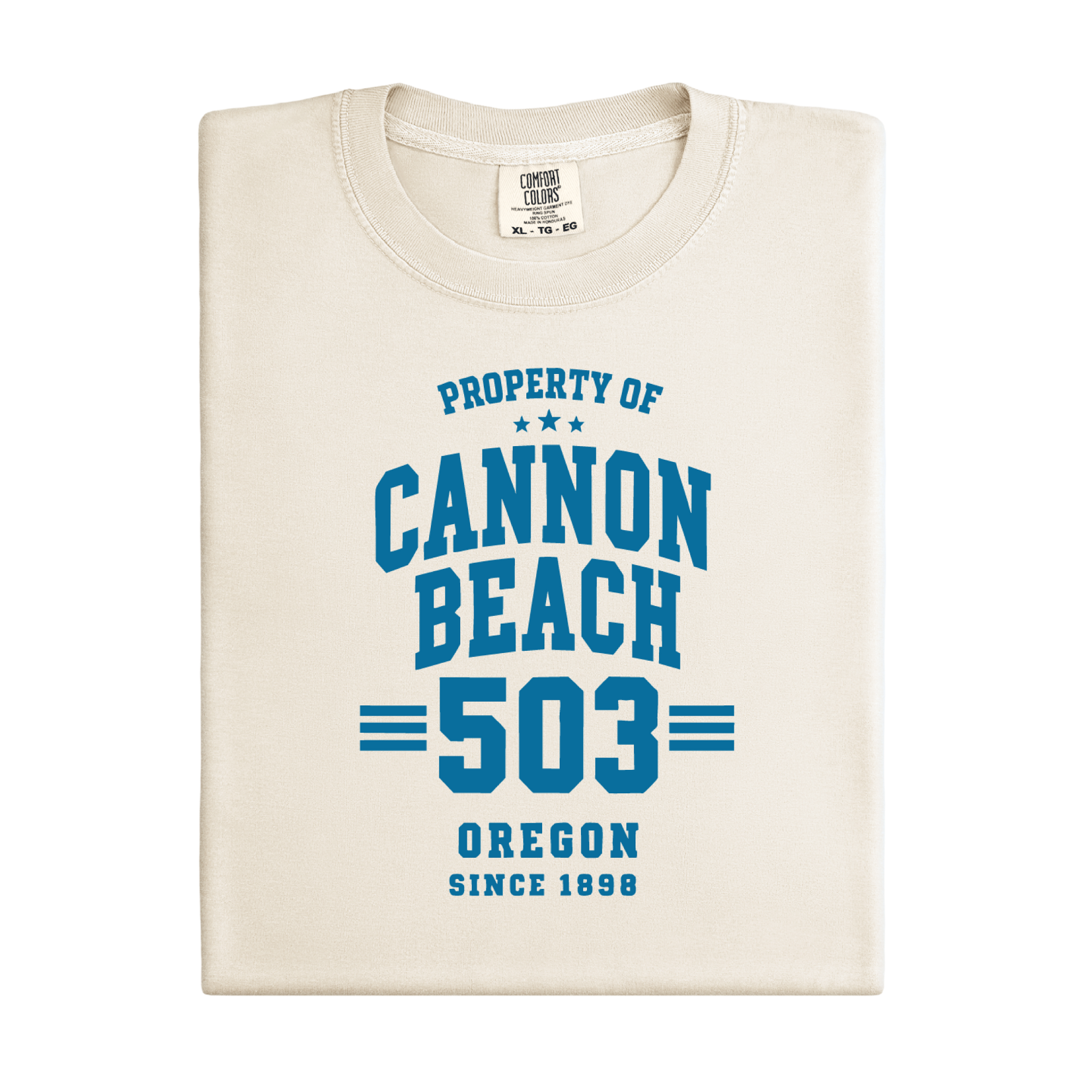 Folded t-shirt with 'Property of Cannon Beach 503 Oregon Since 1898' text on a white background
