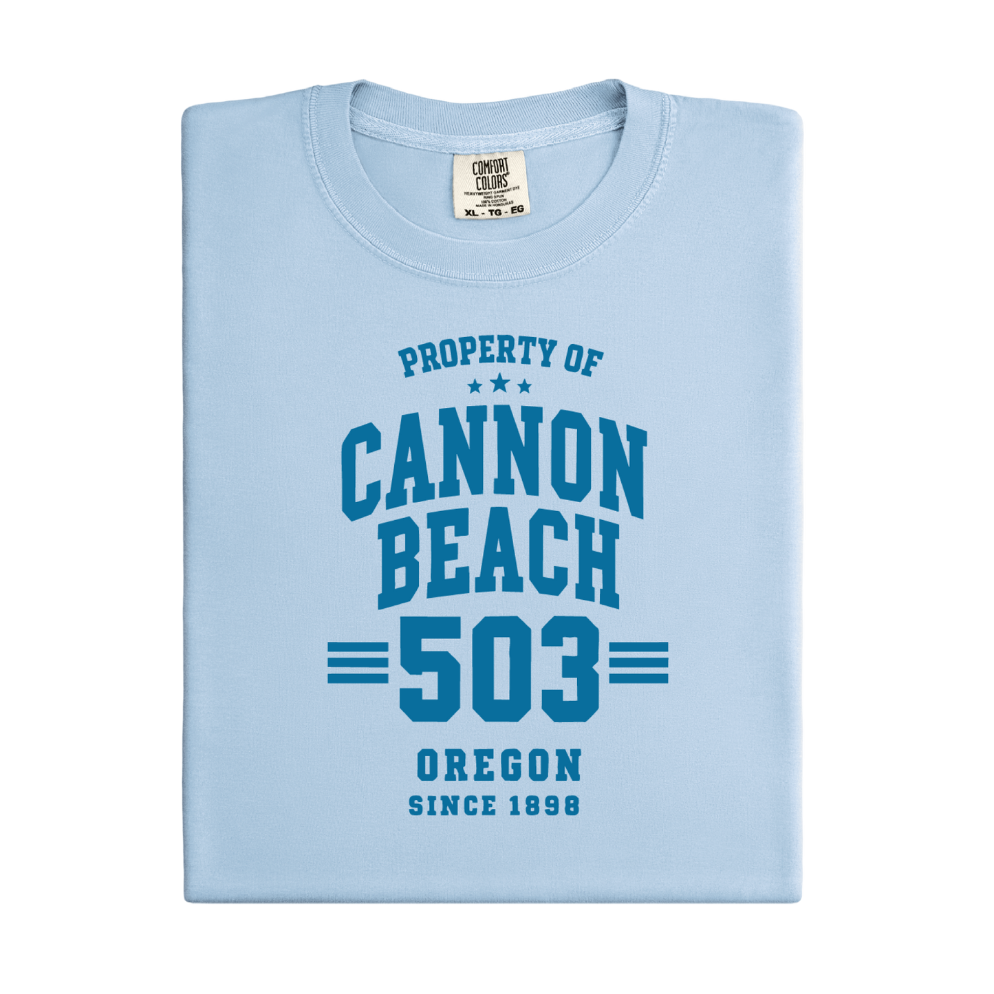 a t-shirt with 'Property of Cannon Beach 503 Oregon Since 1899' text at the beach.