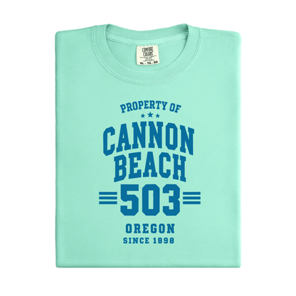 Light green t-shirt with 'Property of Cannon Beach 503 Oregon Since 1898' text on a white background