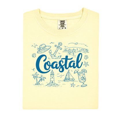 Yellow t-shirt with blue coastal graphics and text on a white background