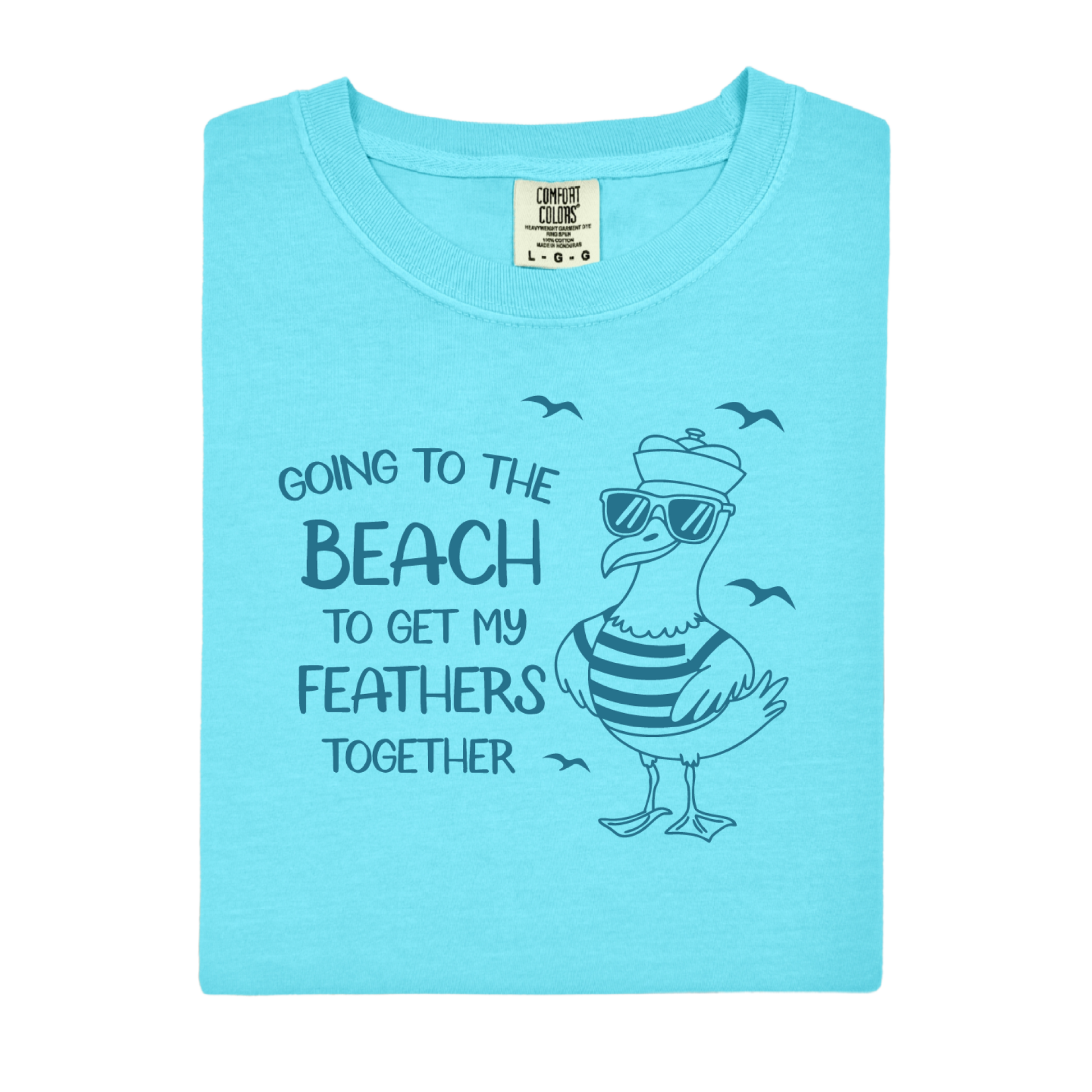 Comfort Colors t-shirt featuring a humorous blue seagull graphic wearing sunglasses and a striped shirt, beside the text “Going to the Beach to Get My Feathers Together.” Several flying birds surround the design, adding a fun coastal feel. This unisex garment-dyed tee offers a soft, vintage texture and relaxed fit, perfect for beach lovers, ocean fans, and anyone who enjoys playful summer graphic shirts.