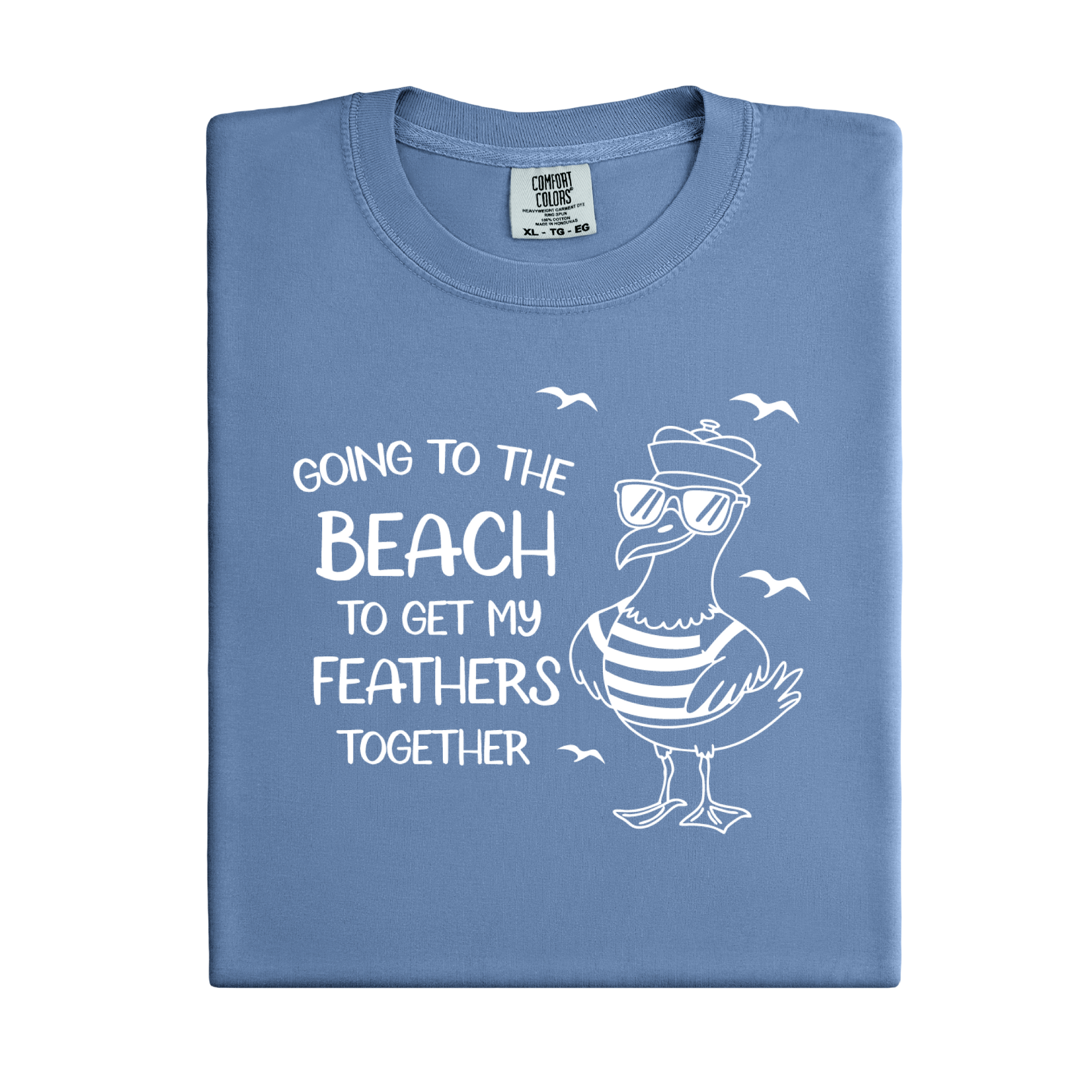 Comfort Colors t-shirt featuring a humorous blue seagull graphic wearing sunglasses and a striped shirt, beside the text “Going to the Beach to Get My Feathers Together.” Several flying birds surround the design, adding a fun coastal feel. This unisex garment-dyed tee offers a soft, vintage texture and relaxed fit, perfect for beach lovers, ocean fans, and anyone who enjoys playful summer graphic shirts.