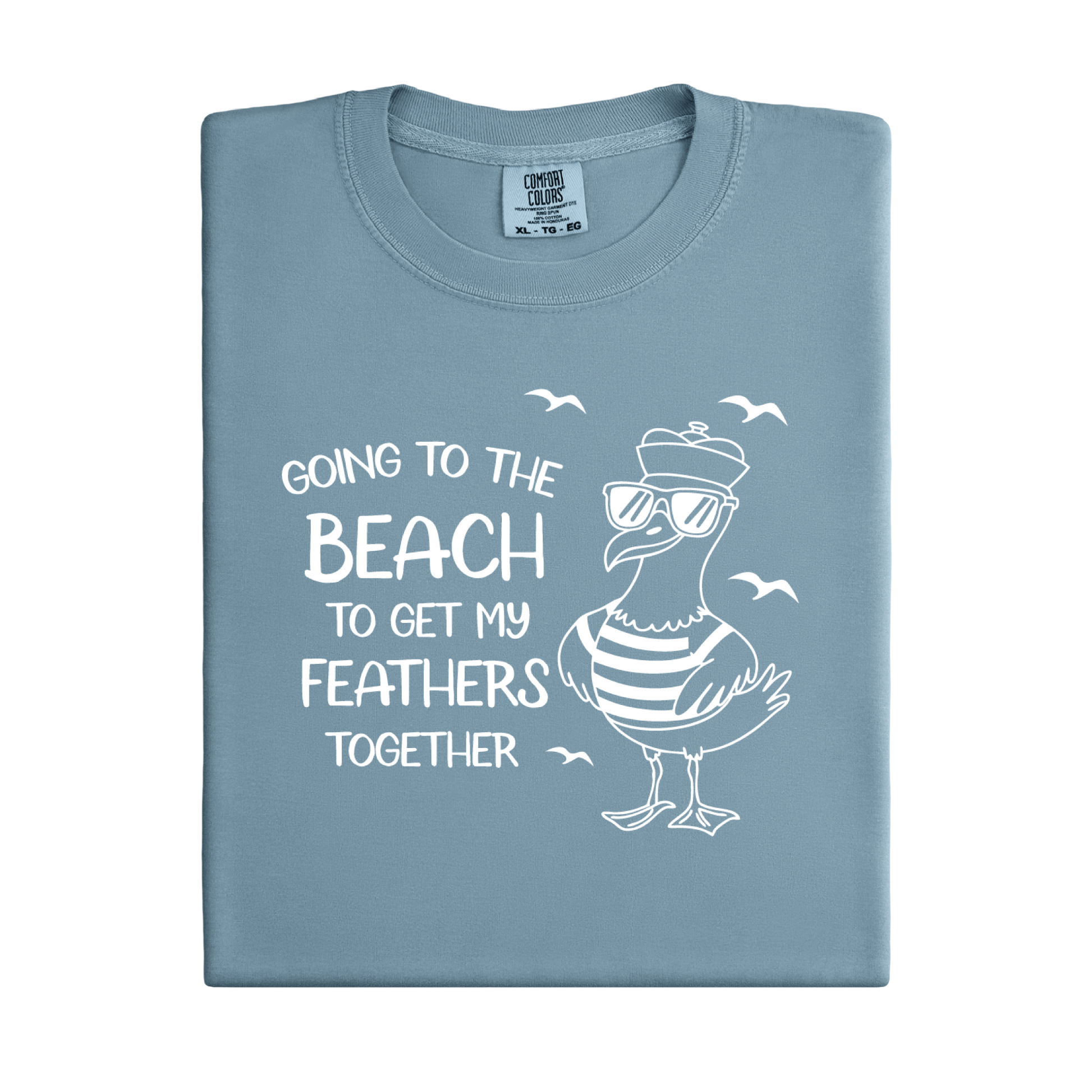 Comfort Colors t-shirt featuring a humorous blue seagull graphic wearing sunglasses and a striped shirt, beside the text “Going to the Beach to Get My Feathers Together.” Several flying birds surround the design, adding a fun coastal feel. This unisex garment-dyed tee offers a soft, vintage texture and relaxed fit, perfect for beach lovers, ocean fans, and anyone who enjoys playful summer graphic shirts.