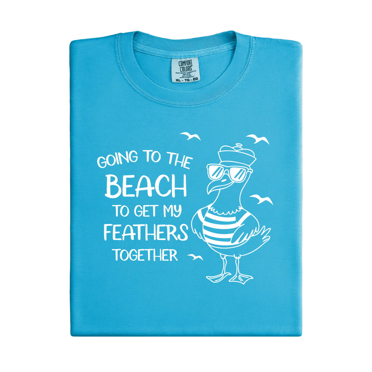 Comfort Colors t-shirt featuring a humorous blue seagull graphic wearing sunglasses and a striped shirt, beside the text “Going to the Beach to Get My Feathers Together.” Several flying birds surround the design, adding a fun coastal feel. This unisex garment-dyed tee offers a soft, vintage texture and relaxed fit, perfect for beach lovers, ocean fans, and anyone who enjoys playful summer graphic shirts.