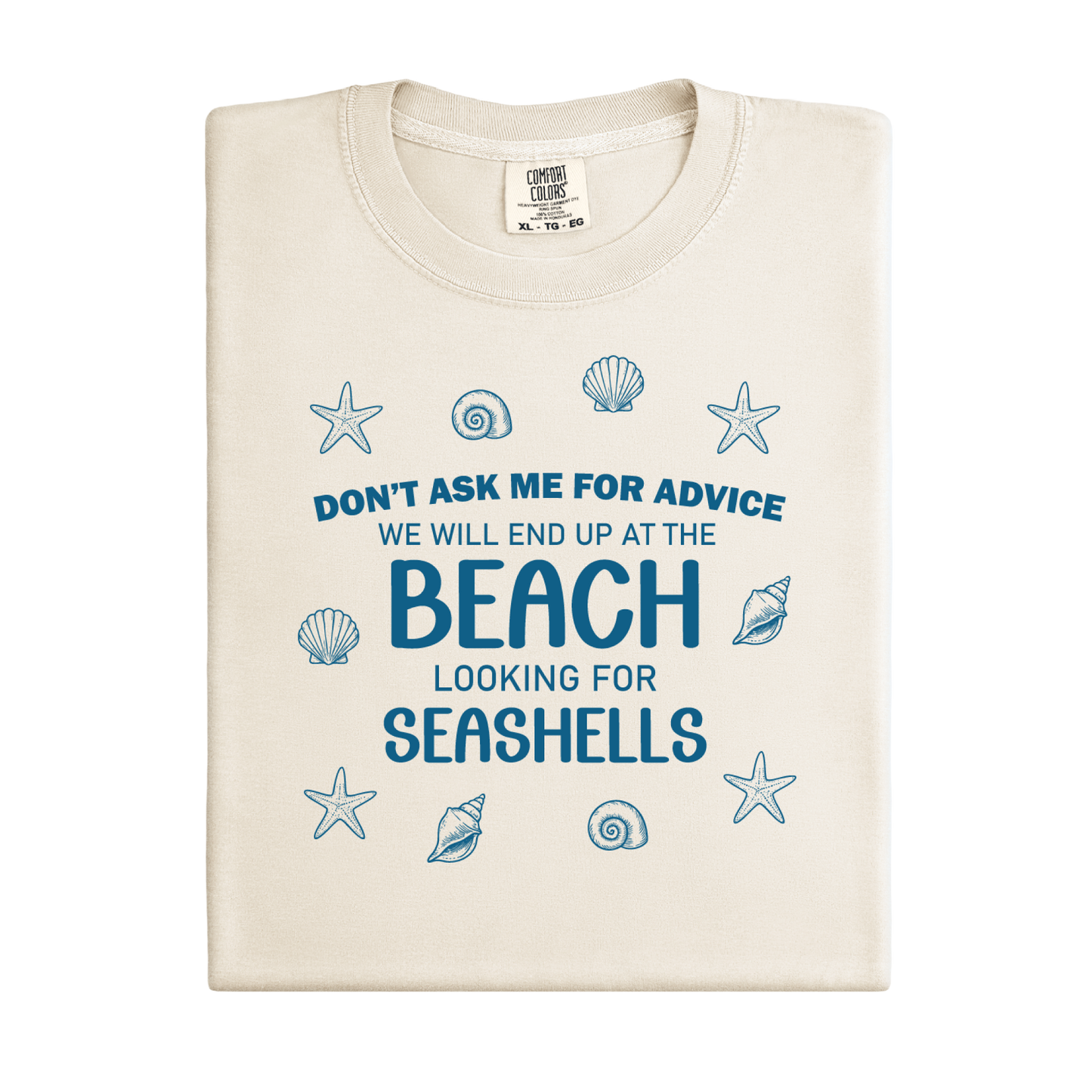 Beige t-shirt with blue text and shell graphics on a white background