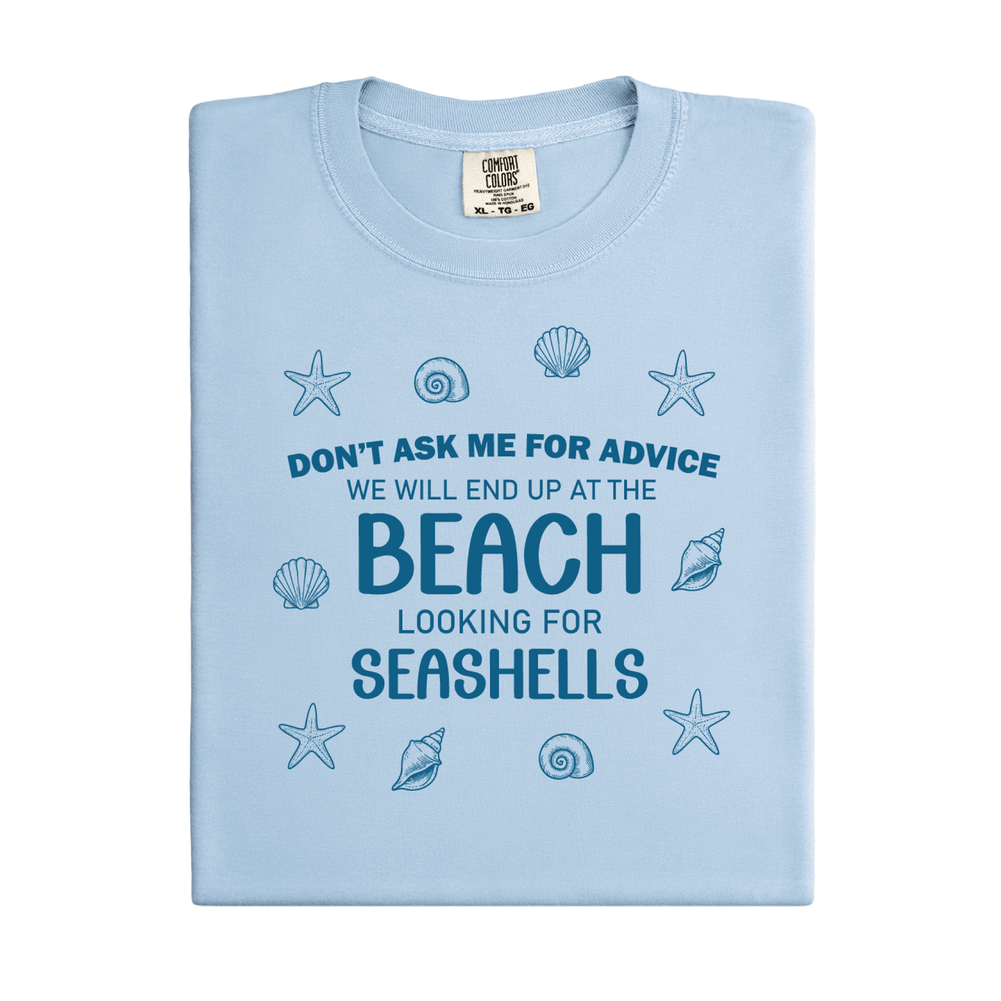 Light blue t-shirt with beach-themed text and shell graphics on a white background