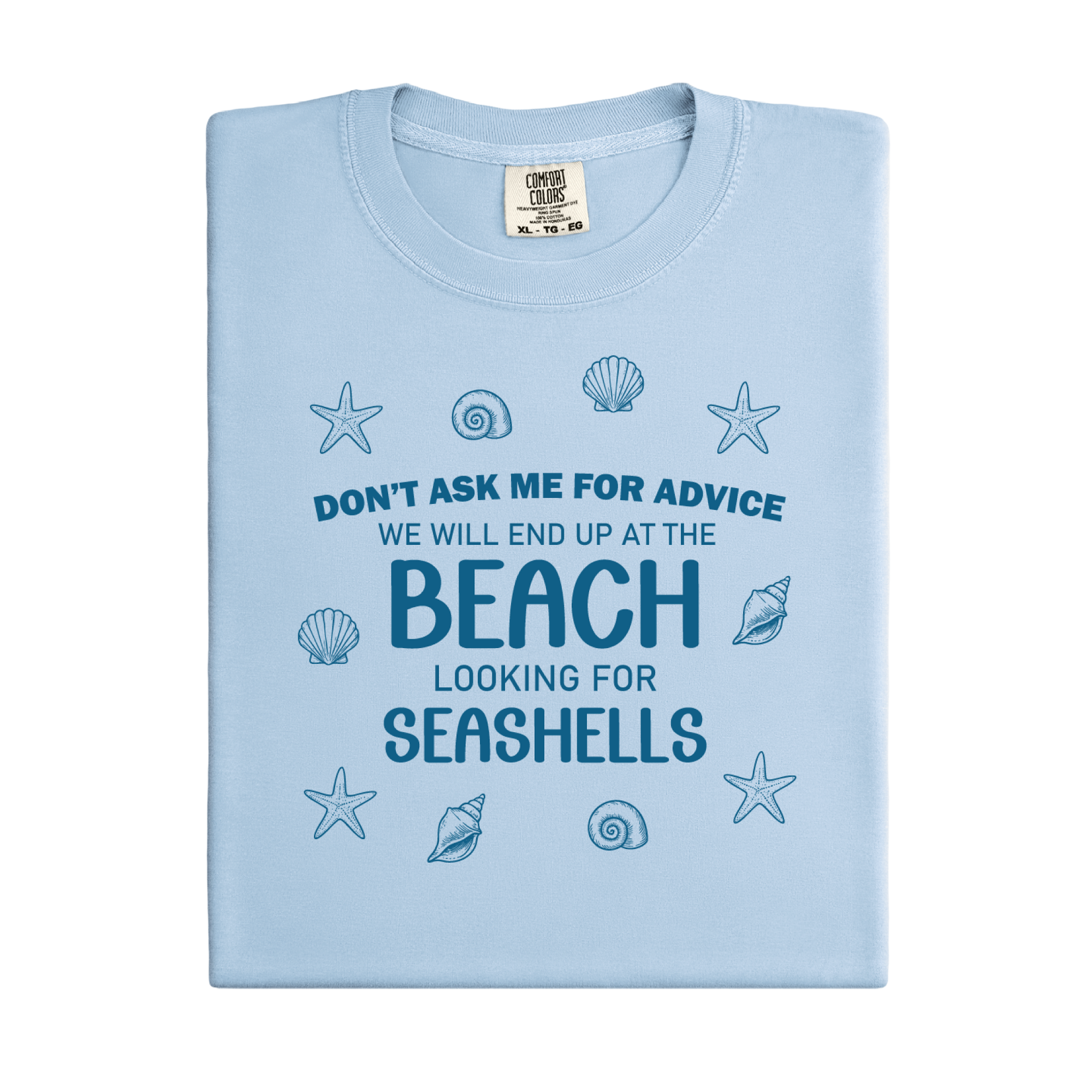Light blue t-shirt with beach-themed text and shell graphics on a white background