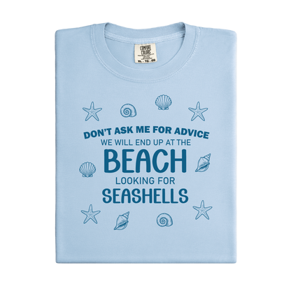 Light blue t-shirt with beach-themed text and shell graphics on a white background