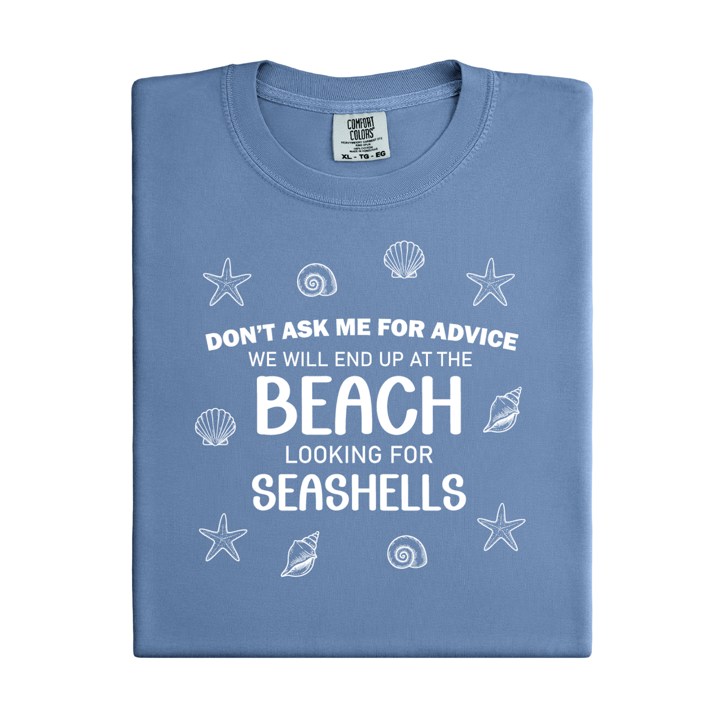 Folded blue t-shirt with beach-themed text and graphics on a white background