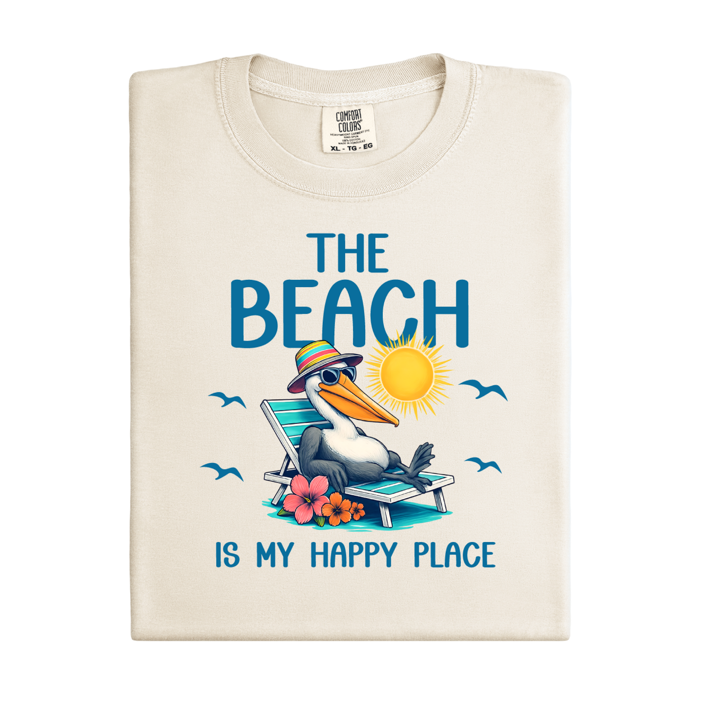 Folded t-shirt with a pelican graphic and text 'The Beach is my happy place' on a white background