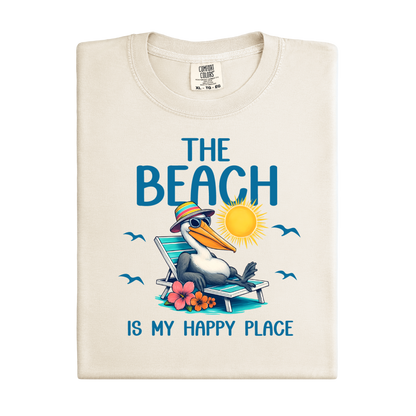 Folded t-shirt with a pelican graphic and text 'The Beach is my happy place' on a white background