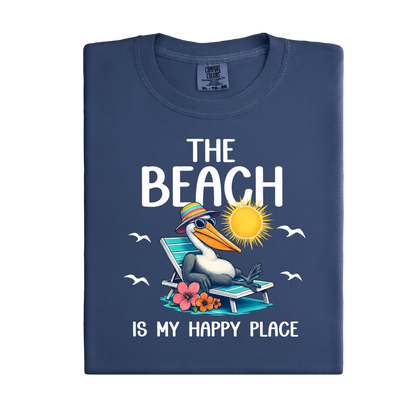 Folded navy blue t-shirt with a beach-themed design featuring a pelican and text on a white background.