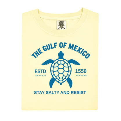 Yellow t-shirt with blue turtle graphic and text on a white background