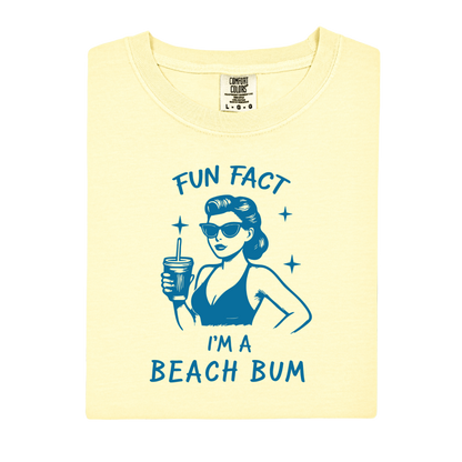 Yellow t-shirt with blue graphic and text 'Fun Fact I'm a Beach Bum' on a white background