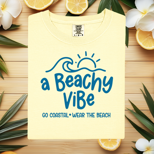 Yellow t-shirt with 'a Beachy ViBe' text and wave design on a white background