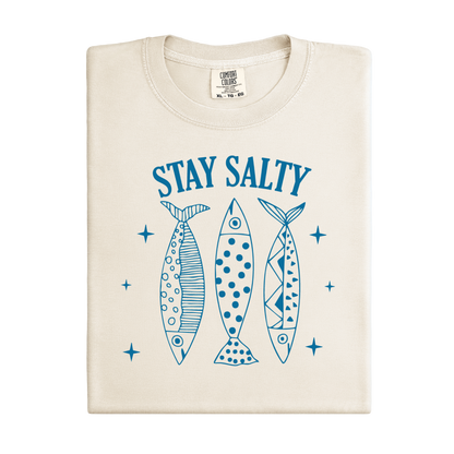 Beige t-shirt with blue graphic of three fish and 'Stay Salty' text on a white background