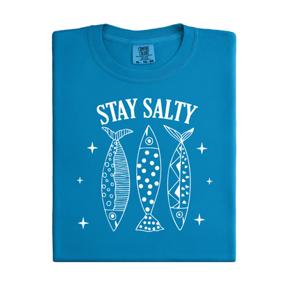 Blue t-shirt with 'Stay Salty' text and fish illustrations on a white background