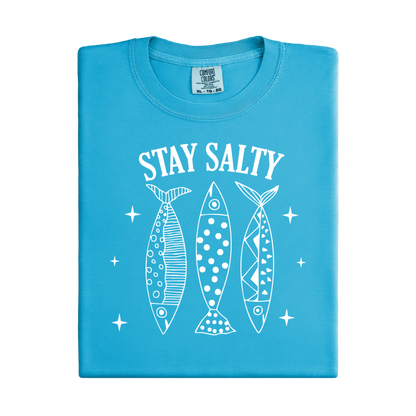 Blue t-shirt with 'Stay Salty' text and fish illustrations on a white background