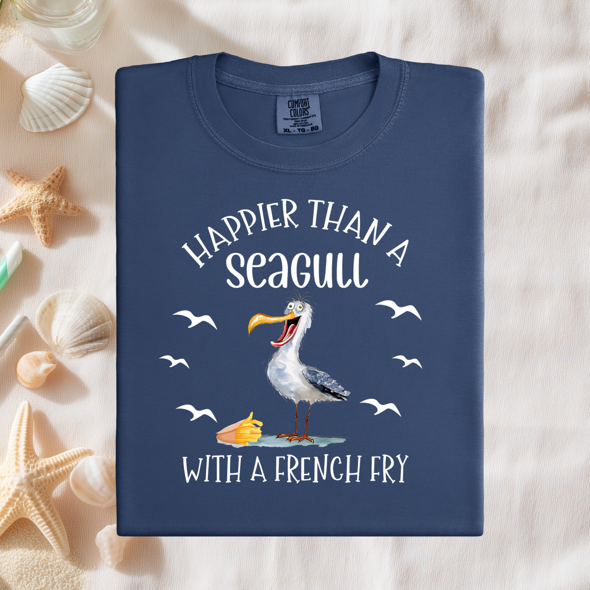 Navy blue t-shirt with a seagull graphic and text on a sandy background