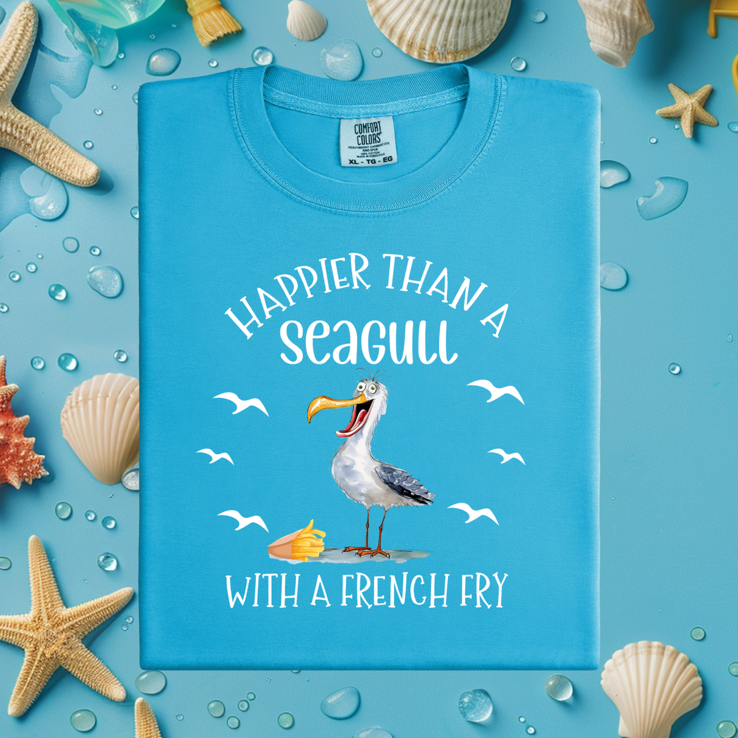 Blue t-shirt with a seagull graphic and text on a blue background with sea-themed decorations.