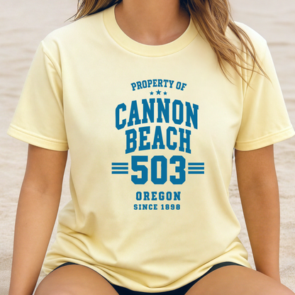 Person wearing a yellow t-shirt with 'Property of Cannon Beach 503 Oregon Since 1896' text.