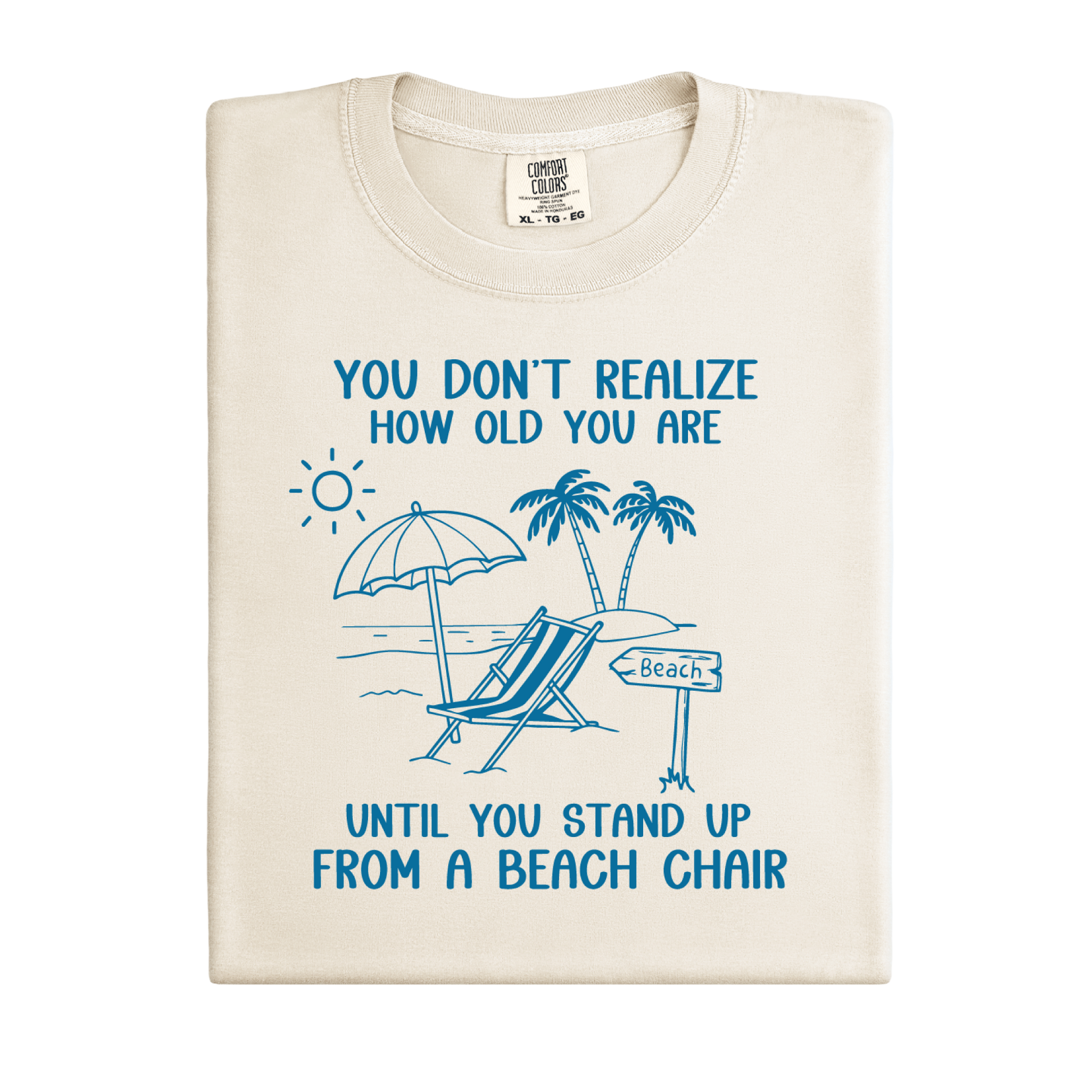 Beige t-shirt with blue beach-themed design and text on a white background
