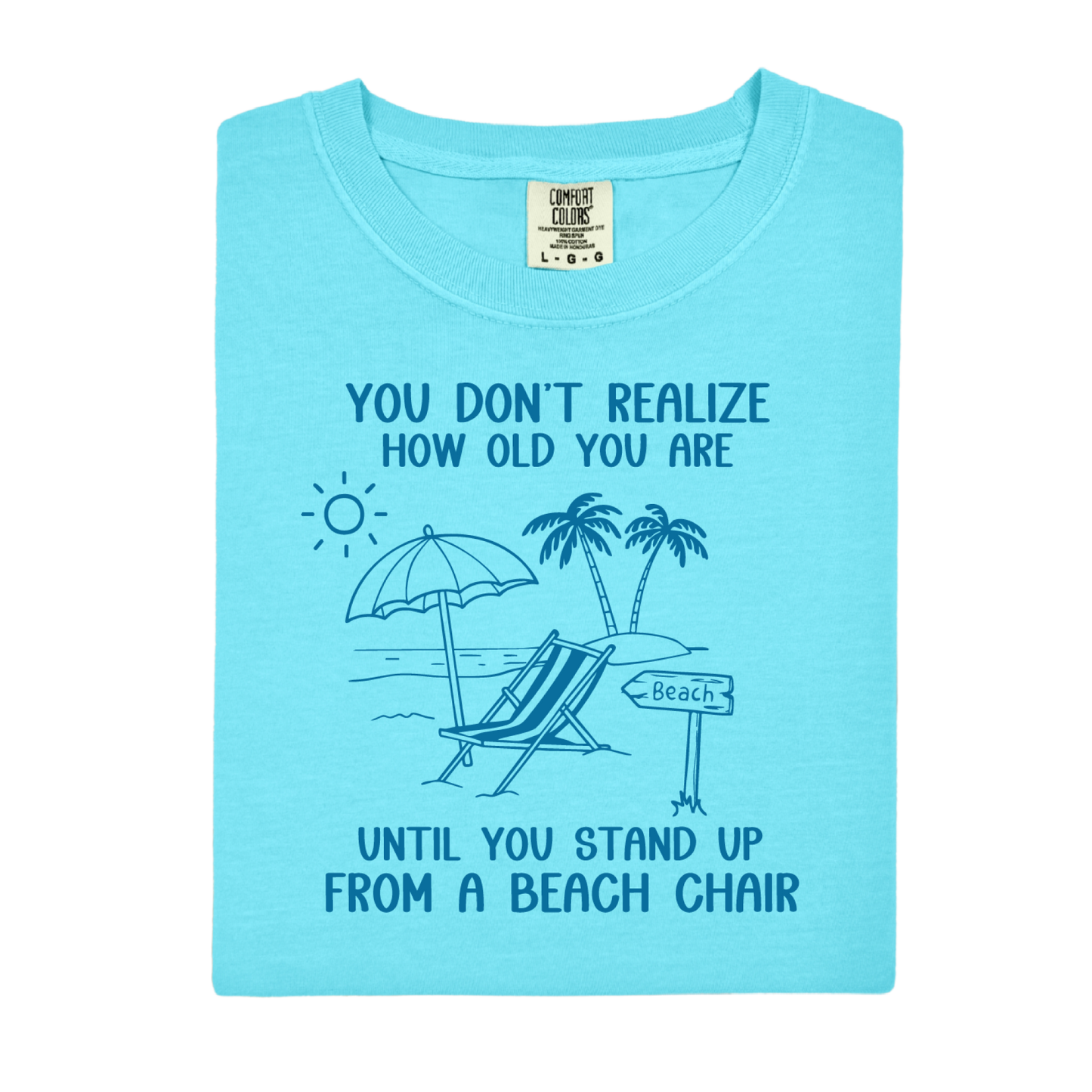 Light blue t-shirt with beach graphic and text on a white background