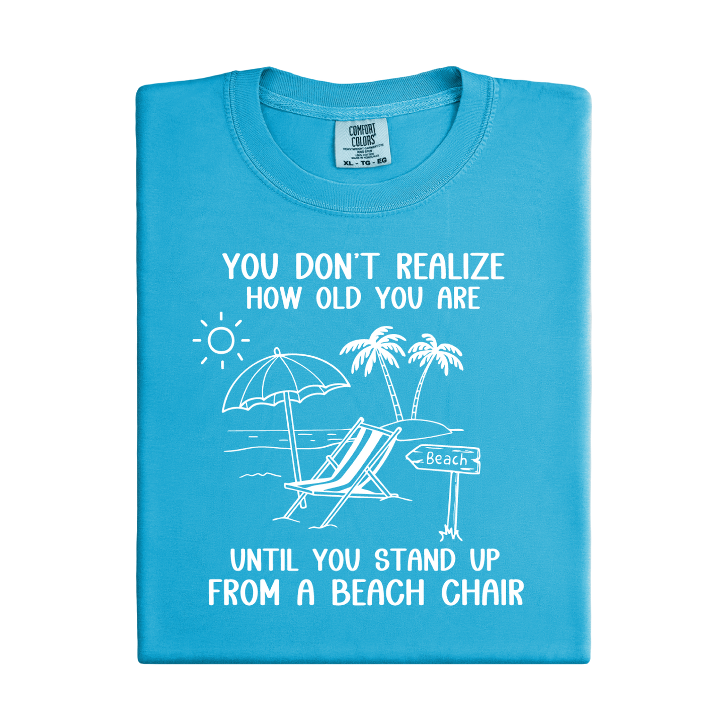Blue t-shirt with beach-themed graphic and text on a white background