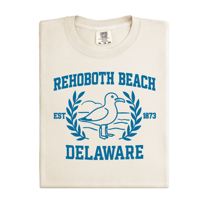 Ivory t-shirt with blue Rehoboth Beach Delaware design on a white background