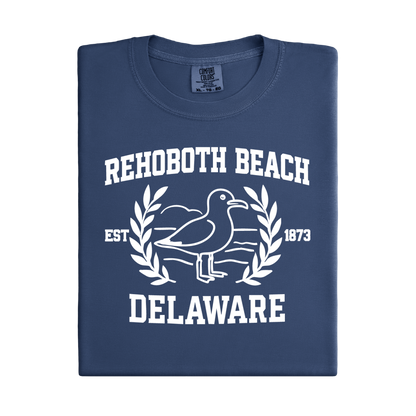Folded navy blue t-shirt with white text and seagull design on a white background
